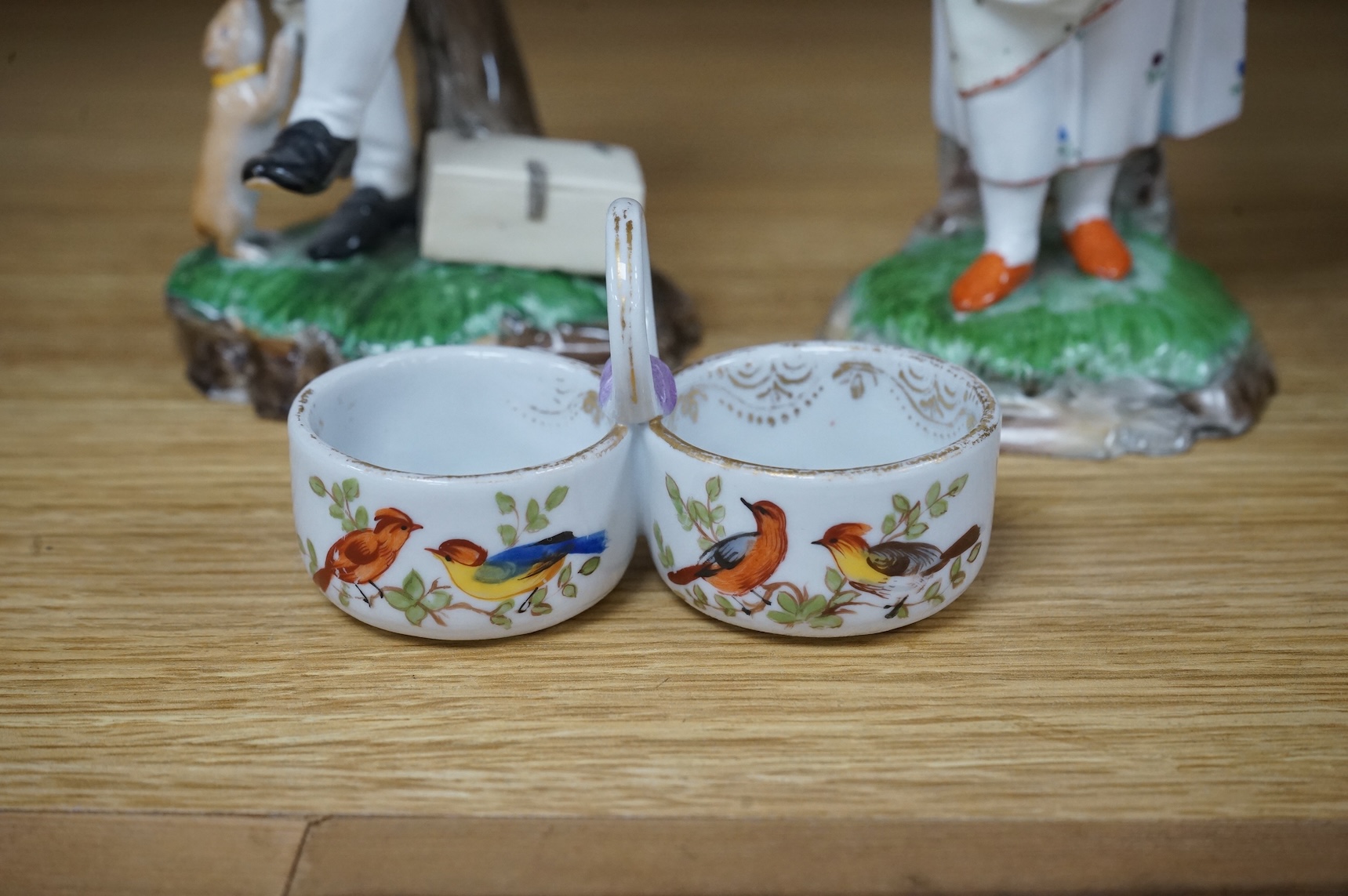 A pair of 19th century Hochst Damm faience figures and a Meissen twin section salt, tallest figure 20cm
